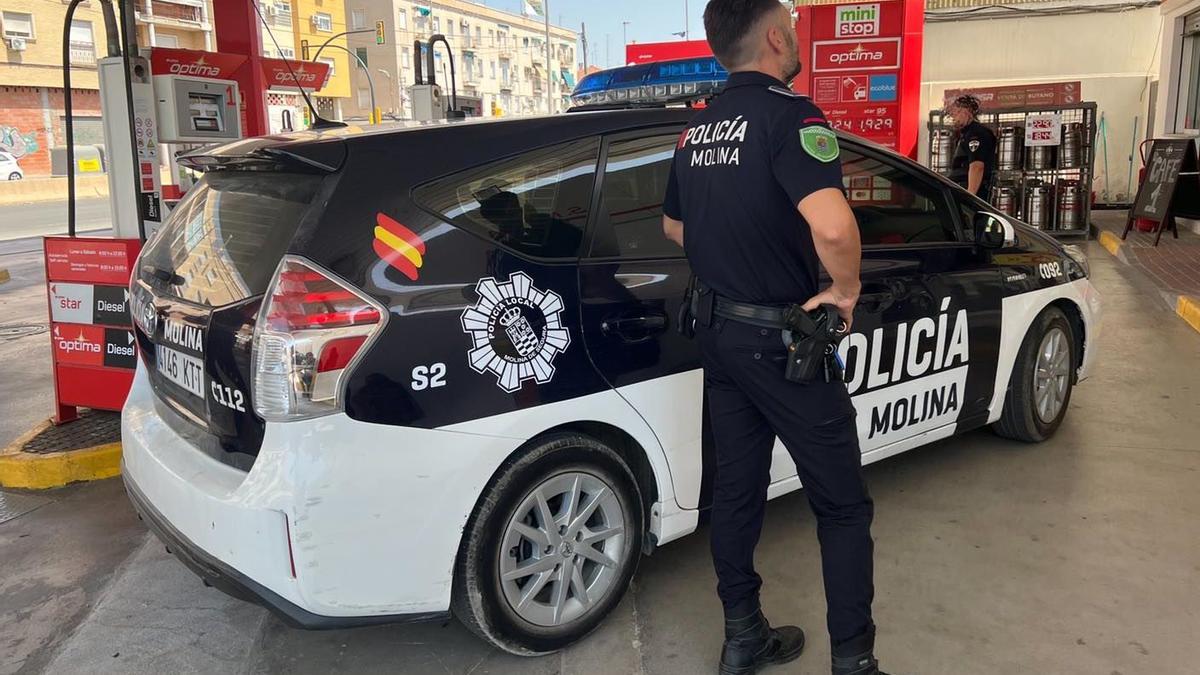 Dos agentes de la Policía Local de Molina de Segura, junto a un vehículo del cuerpo.