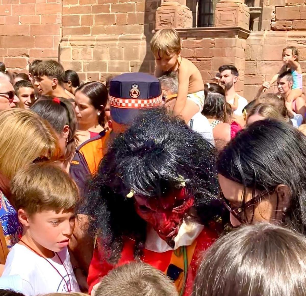 La diablilla comprueba si nos niños tienen o no medalla de San Bartolomé.