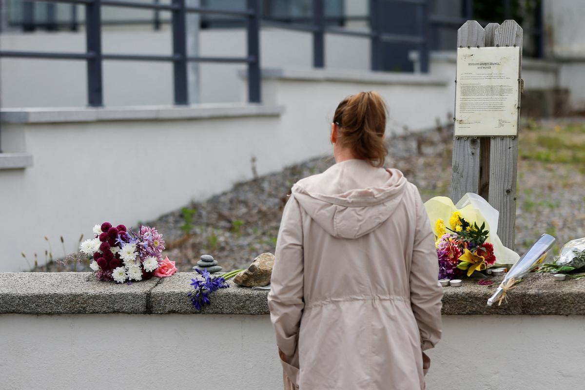 Una mujer observa los homenajes dejados ante la casa irlandesa de Sinéad OConnor en Bray, la costa irlandesa