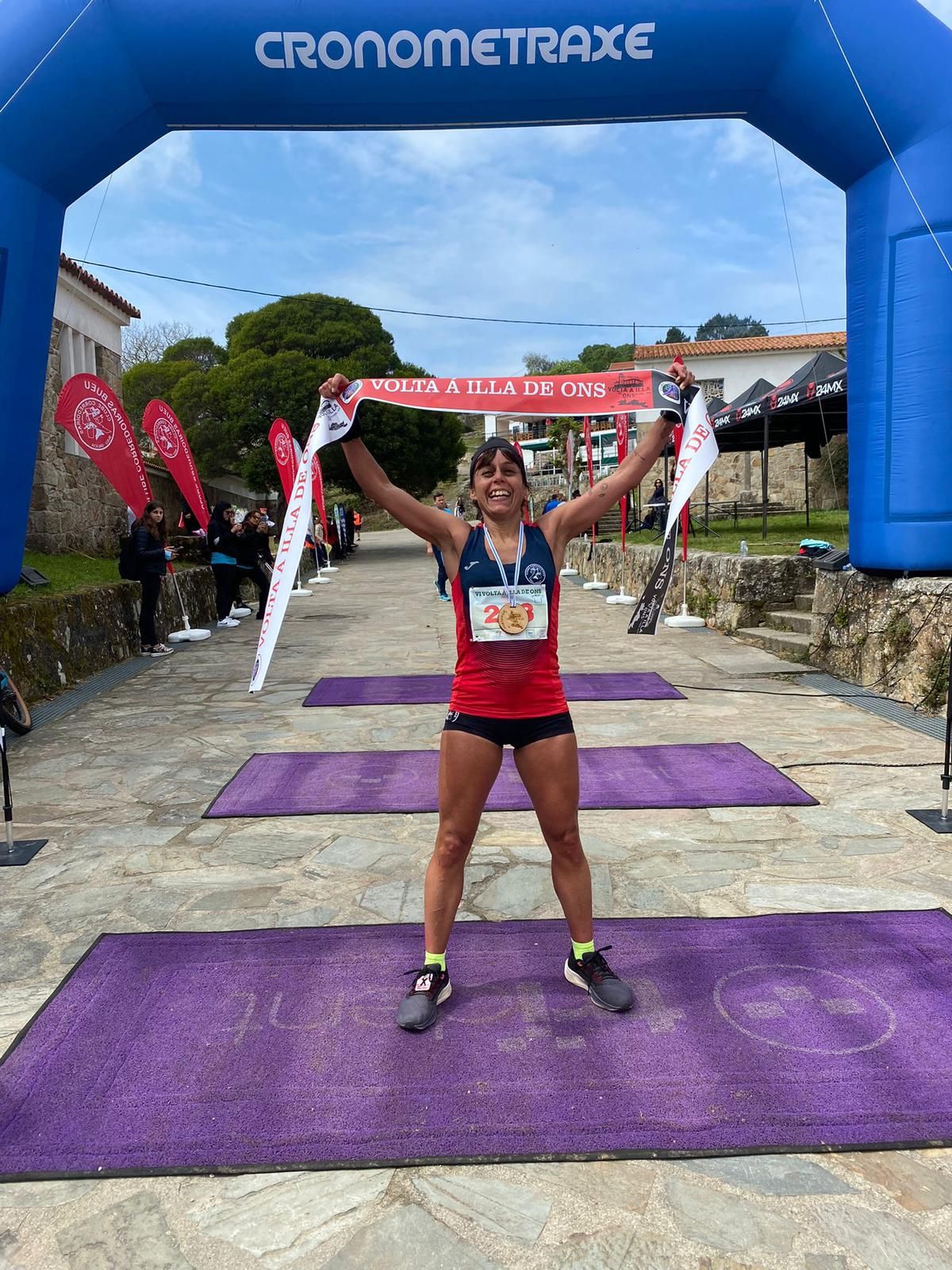 La corredora Beatriz Fernández celebra ayer su triunfo en la VI Volta á Illa de Ons tras cruzar la línea de meta.