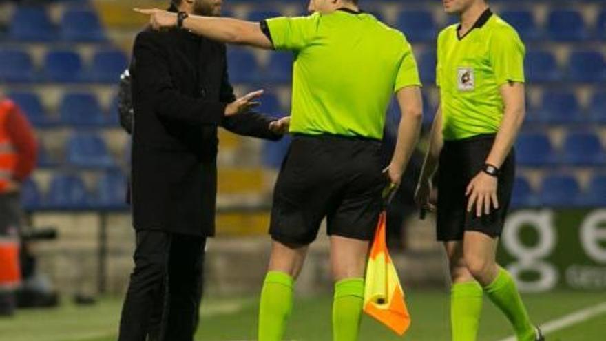 El técnico Lluís Planagumà dialoga con el colegiado Montes García en el Hércules-Ebro.