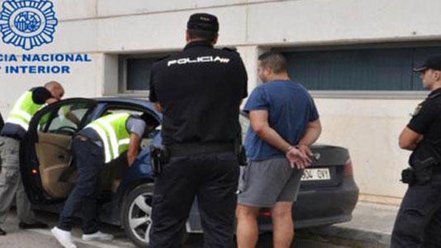 Varios agentes inspeccionan el coche del acusado.