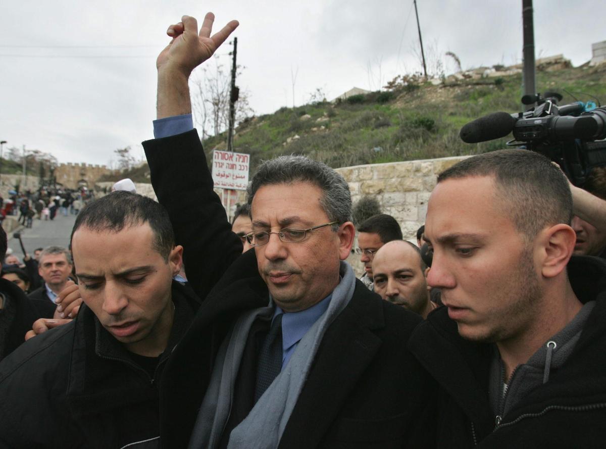 Israeli plainclothes policemen escort Palestinian presidential candidate Mustafa Barghouti, center, as he is detained trying to enter Jerusalem's Old City to pray at the al Aqsa mosque compound Friday Jan. 7, 2005. Israeli police said Barghouti had violated an agreement not to campaign at the sensitive mosque compound. Elections to choose a successor to the late Yasser Arafat are scheduled for Jan. 9. (AP Photo/Kevin Frayer) / BARGHUTI