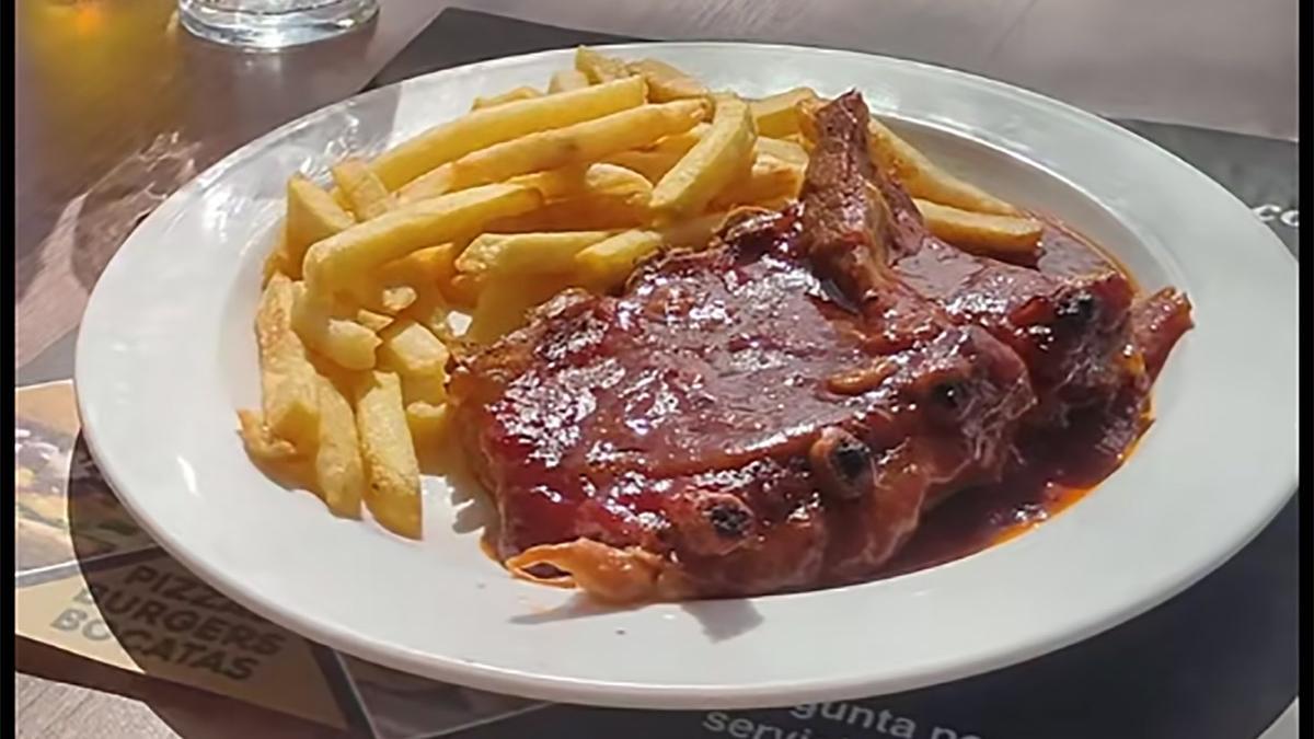 Plato de costillas y patatas del medio menú.