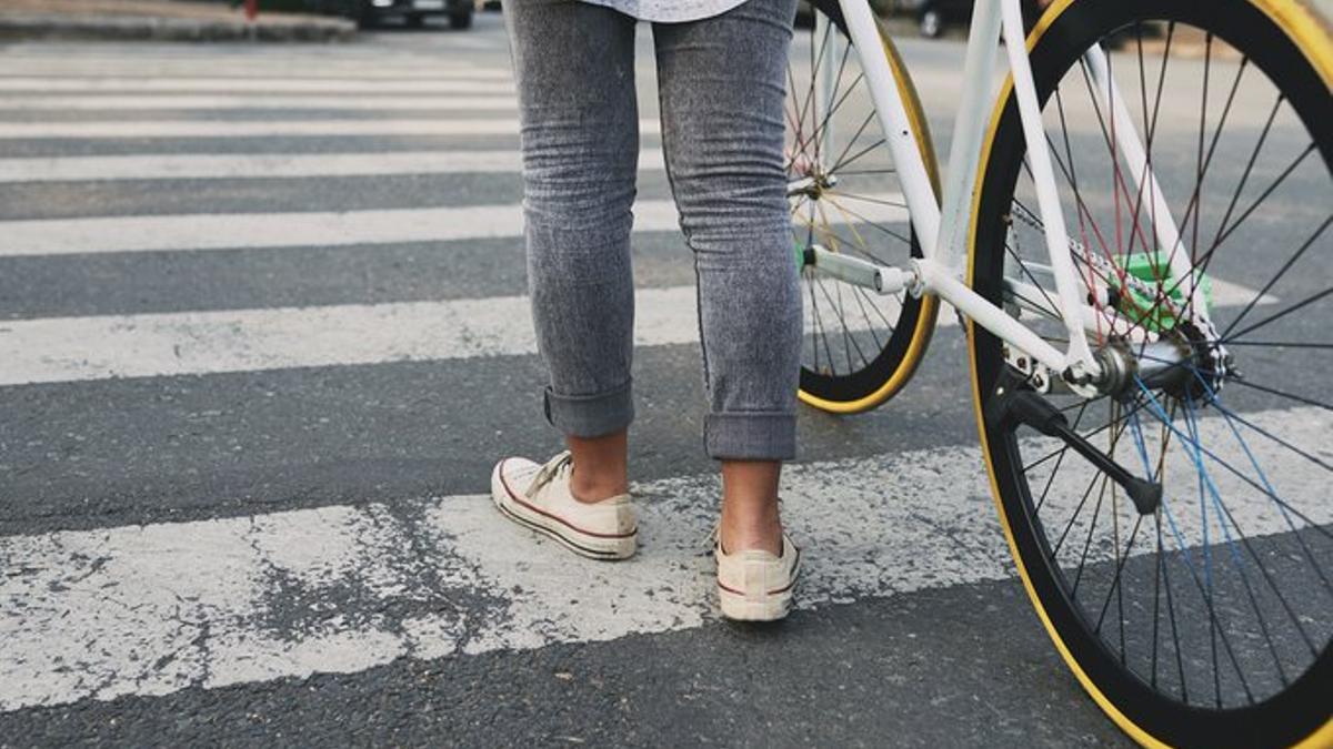 Un ciclista cruza un paso de peatones de manera correcta