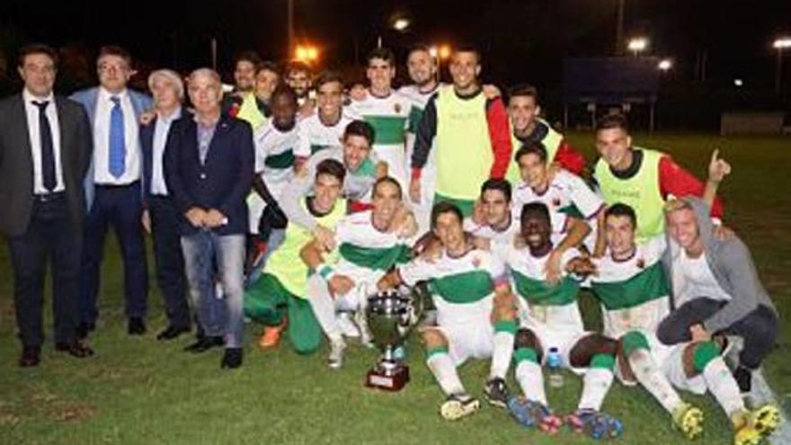 Jugadores y directivos del Elche, con la Copa de campeones, al final del encuentro.