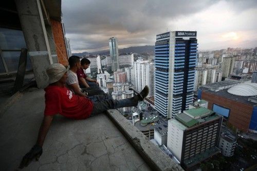 Men rest after salvaging metal on the 30th floor of the "Tower of David" skyscraper in Caracas