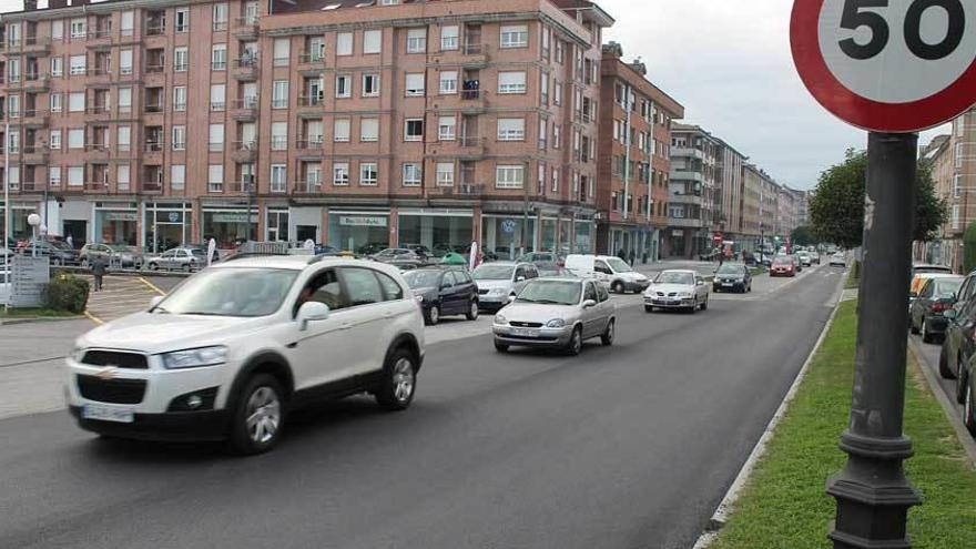 Coches circulando sobre el nuevo asfalto, ayer, en la avenida de Gijón.