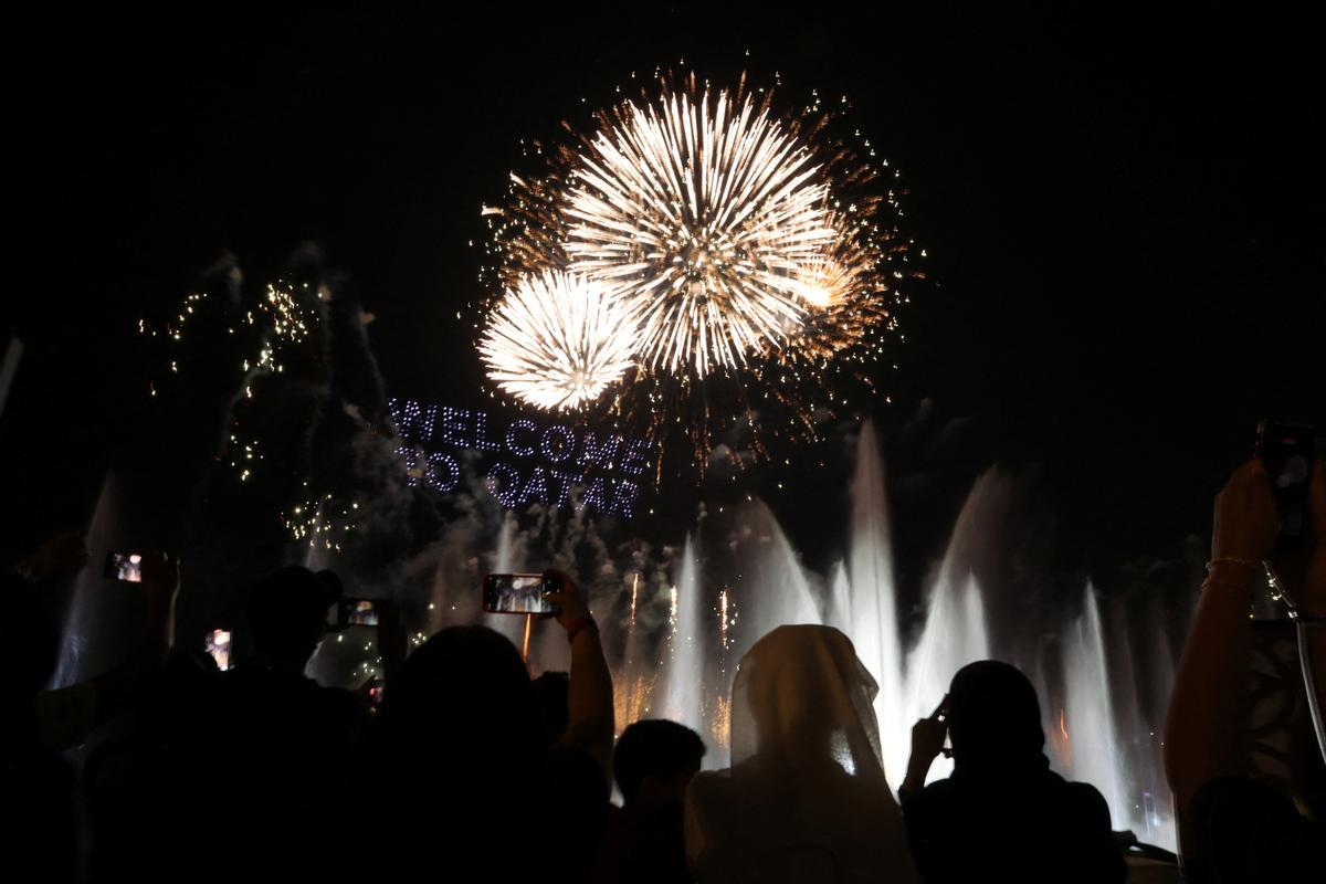 People watch fireworks and a light show on The Corniche waterfront in Doha, Qatar.