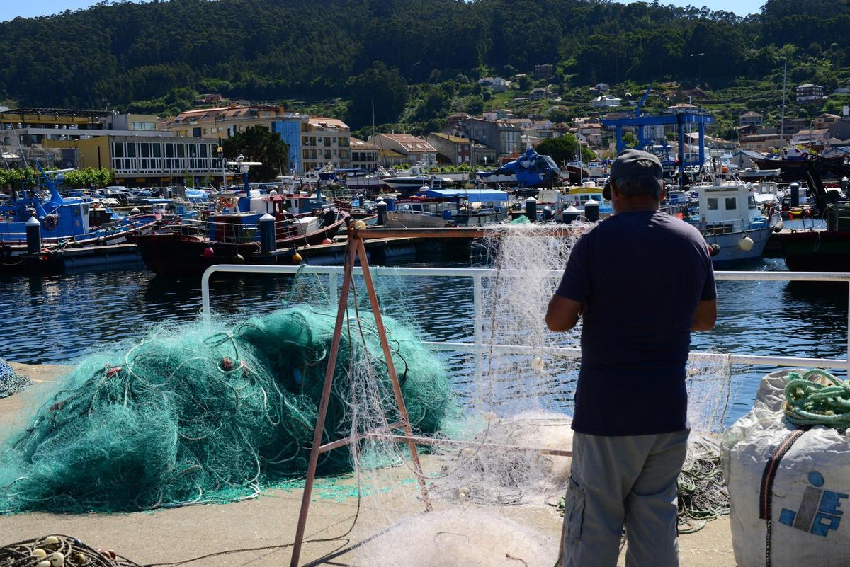 Un marinero preparando los aparejos en tierra, en el puerto de Bueu.
