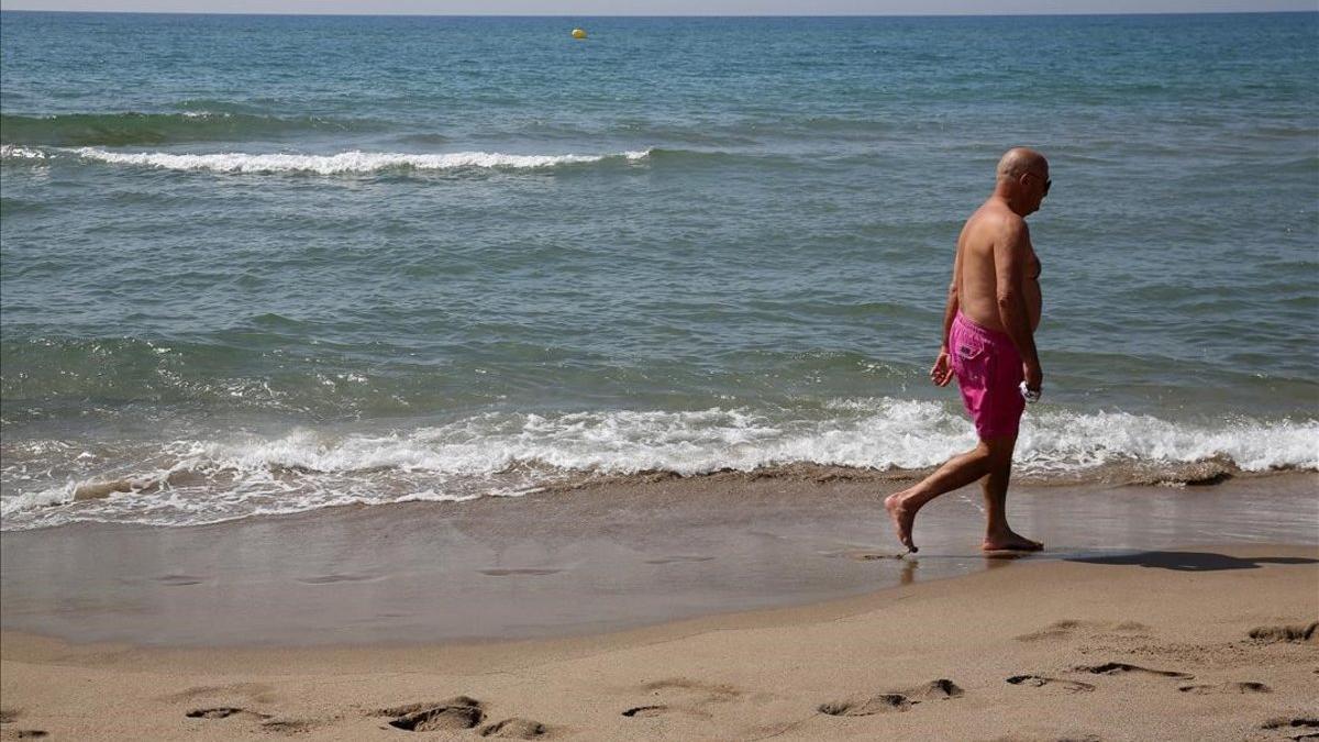 Un hombre pasea por la playa de Gavà, el verano pasado