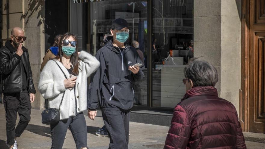 Persones passegen amb mascareta per Barcelona