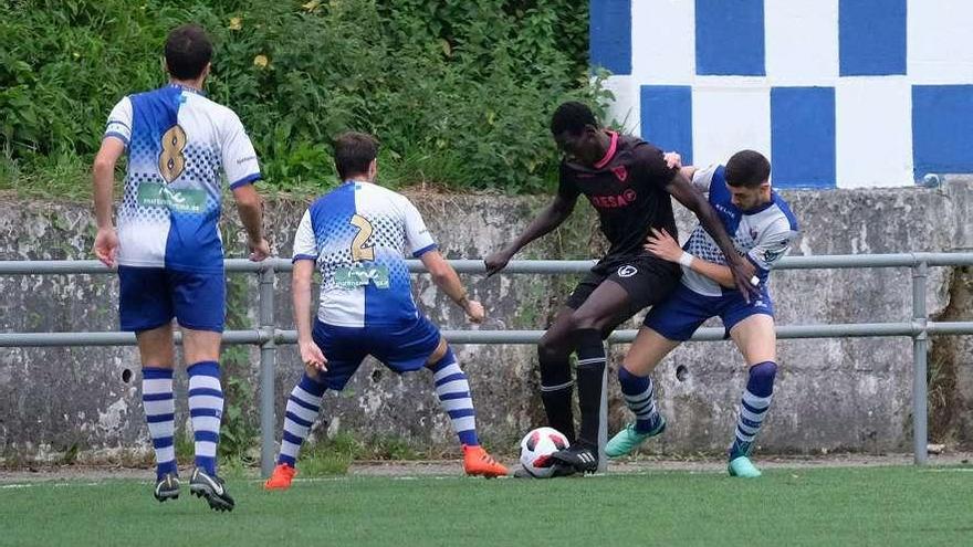 Saha controla el balón rodeado de jugadores del Tuilla.