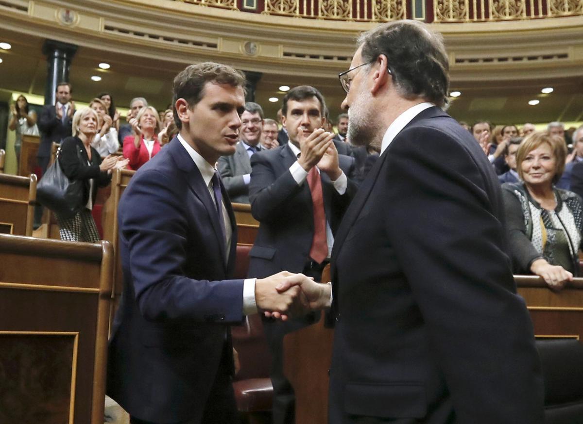 GRA473. MADRID, 29/10/2016.- El líder del PP y presidente del Gobierno en funciones, Mariano Rajoy (d), es felicitado por el líder de Ciudadanos, Albert Rivera, tras ser investido hoy presidente del Gobierno por mayoría simple al conseguir 170 votos a favor, del PP, Ciudadanos, CC, Foro y UPN, 111 en contra y 68 abstenciones de socialistas, esta tarde en la Cámara Baja. EFE/Juan Carlos Hidalgo