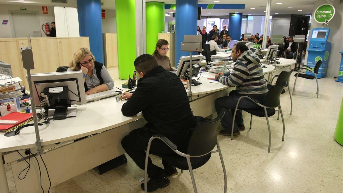 Empleados públicos atienden a ciudadanos en una oficina, en una fotografía de archivo.