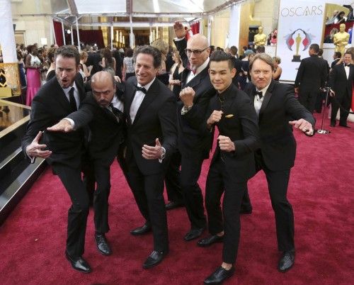 The cast and crew from "BIG HERO 6" pose together as they arrive at the 87th Academy Awards in Hollywood