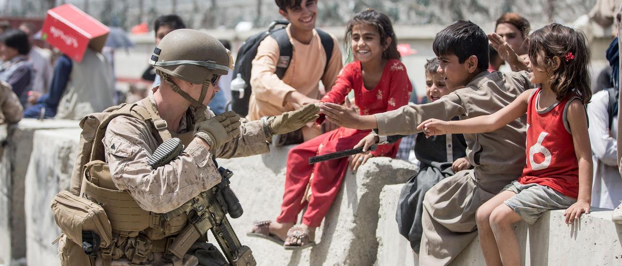 Un soldado estadounidense juega con un niño en Kabul.