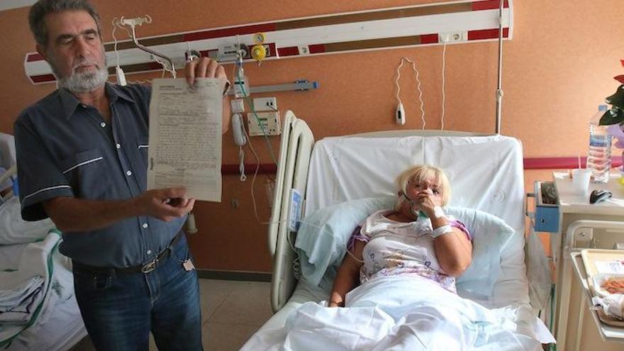 Pepe Subires sostiene la denuncia que presentó en el hospital. Al fondo, su mujer, cuando estaba hospitalizada.