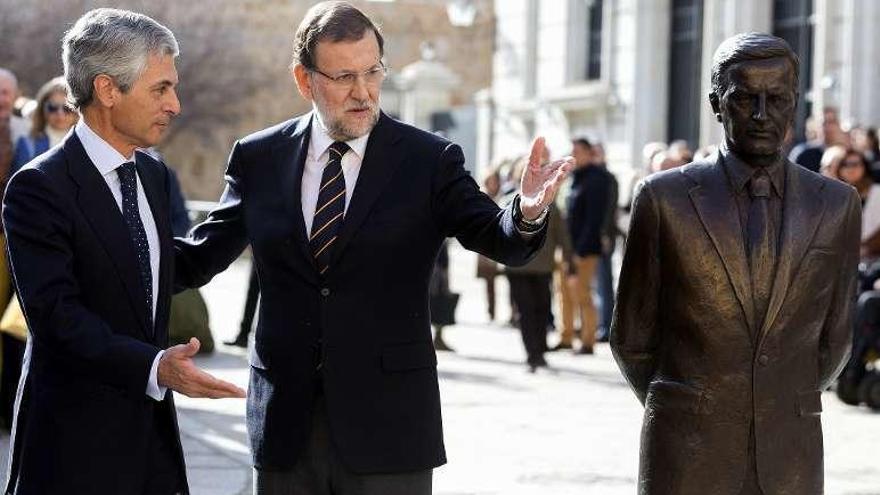 Suárez Illana y Mariano Rajoy, junto a la estatua del expresidente. // Efe