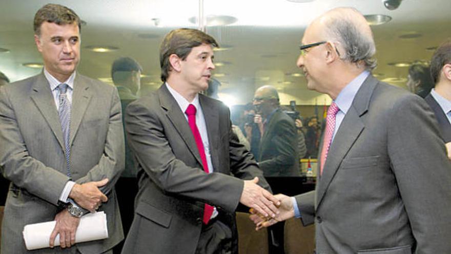 El consejero Javier González Ortiz (centro) saluda al ministro de Hacienda, Cristóbal Montoro