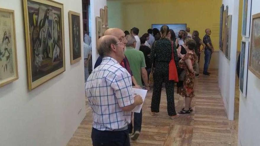 Invitados a la inaguración admiran algunas de las obras seleccionadas para la exposición conmemorativa dedicada a Delhy Tejero en la antigua Iglesia Mercedaria.