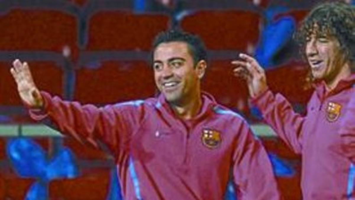 Xavi y Puyol, anoche durante el entrenamiento del Barça.