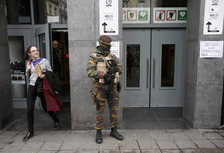 A Belgian soldier stands guard outside a concert hall in central Brussels after security was tightened in Belgium following the fatal attacks in Paris