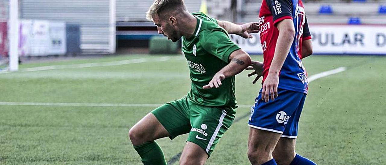 César protege el balón ante un jugador del Langreo. | Irma Collín