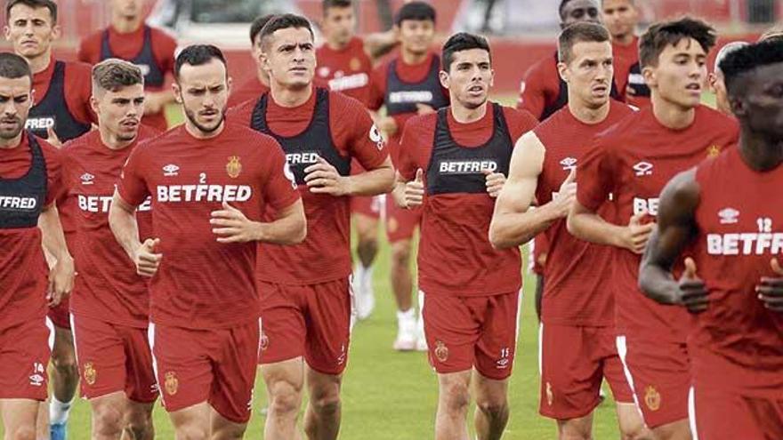 Jugadores del Mallorca, con gesto serio, en el entrenamiento de ayer.