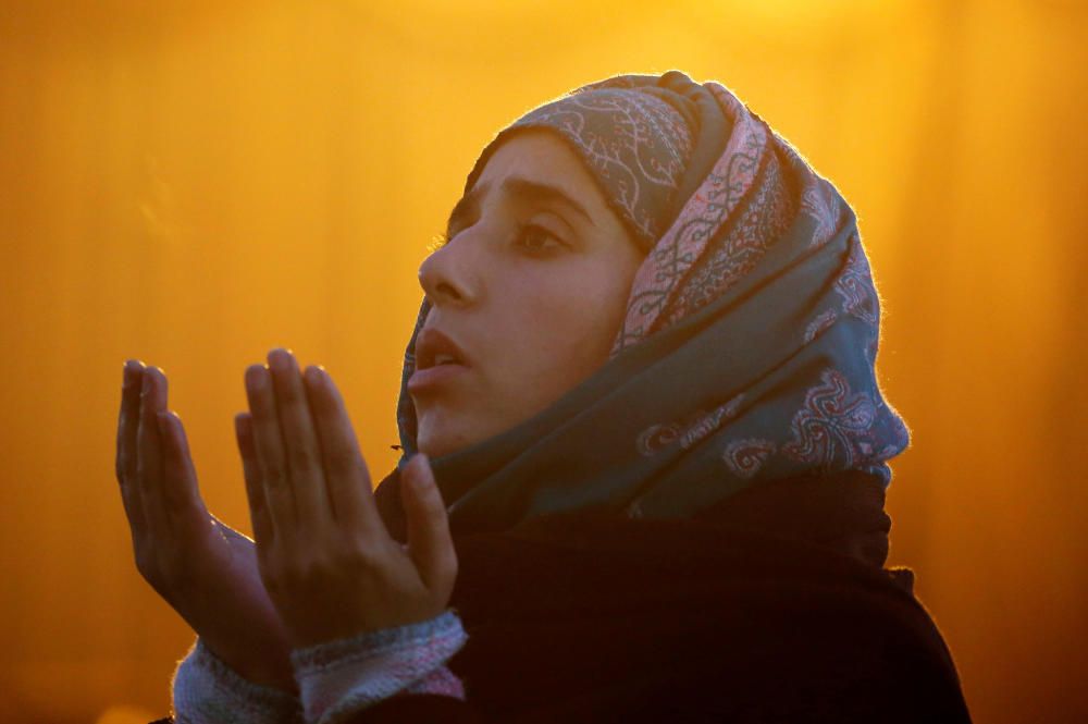 A woman prays during the festival of ...