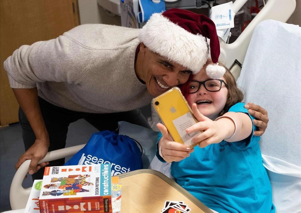 El expresidente Obama entrega un regalo de navidad en el Centro Nacional de Medicina Infantil en Washington