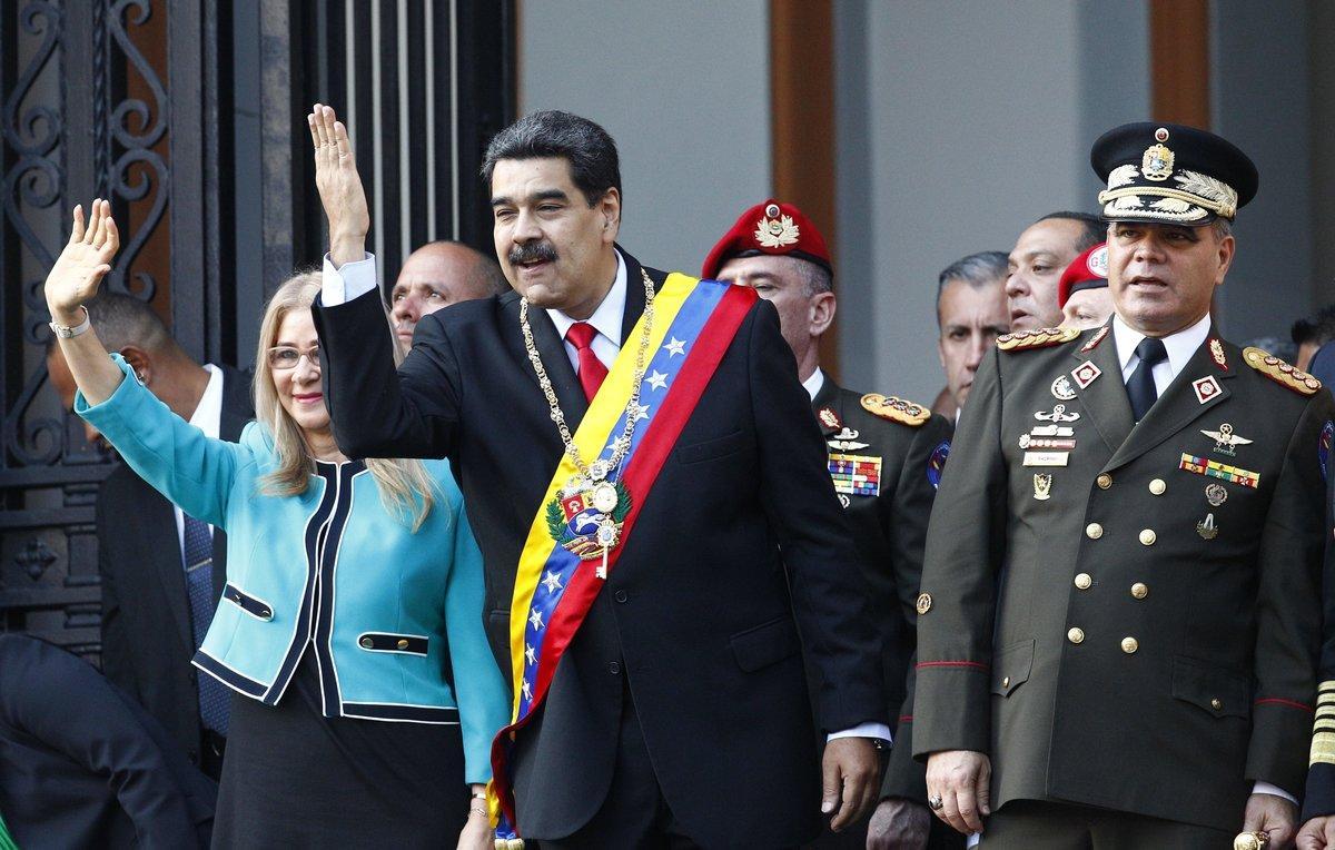 Venezuela s President Nicolas Maduro  center  and his first lady Cilia Flores  wave to supporters as they leave the National Pantheon after attending a ceremony to commemorate an 1800 s independence battle  in Caracas  Venezuela  Wednesday  Aug  7  2019  Sweeping new U S  sanctions freeze all of the Maduro government s assets in the U S  and even threaten to punish companies from third countries that keep doing business with his socialist administration  The first couple is accompanied by Defense Minister Gen  Padrino Lopez   AP Photo Leonardo Fernandez