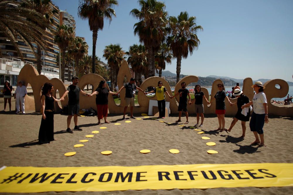 People hold hands after taking part in a ...