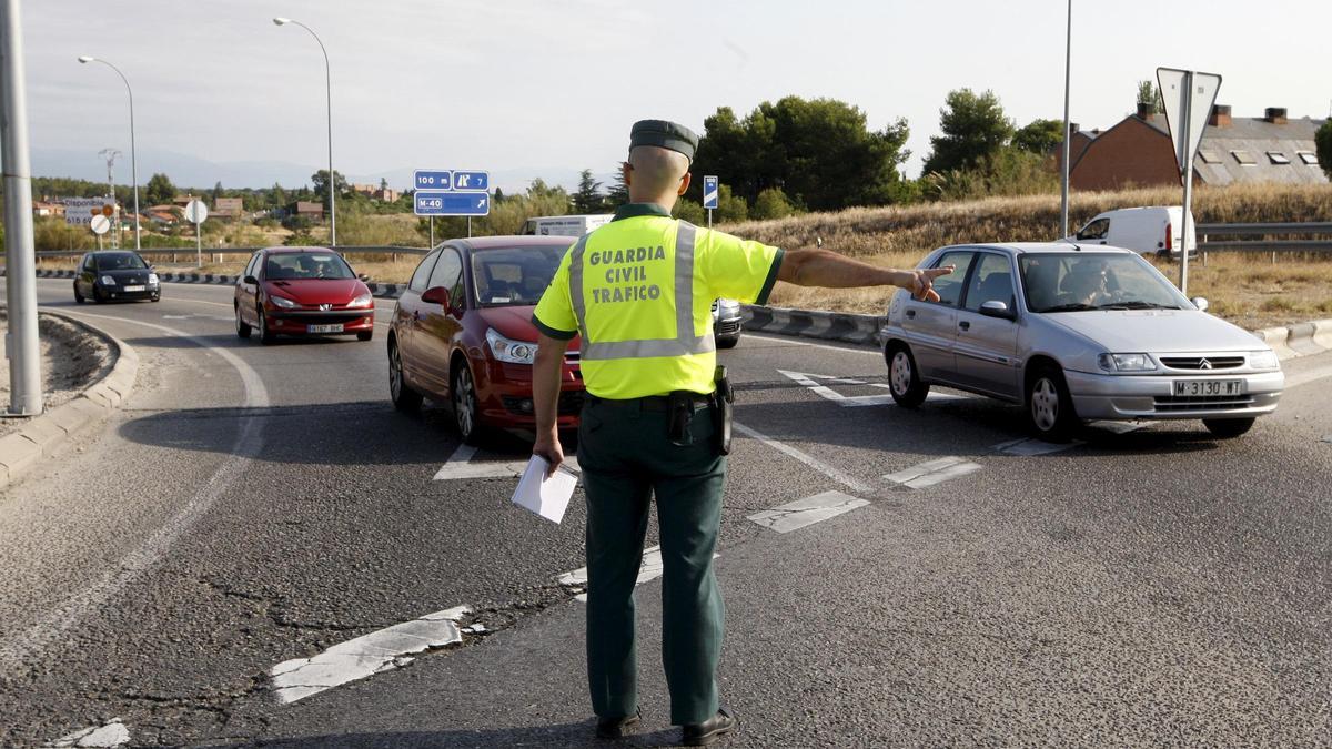 Un guardia civil da el alto a un coche en un control