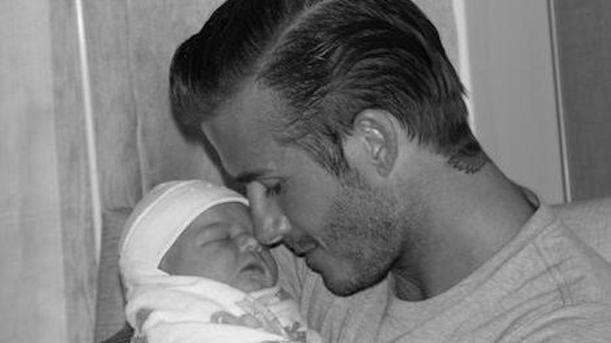 David Beckham con su hija en brazos.