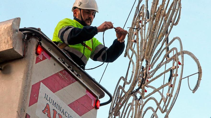 Un operario instala luces para el desfile en García Barbón. // M.G. Brea