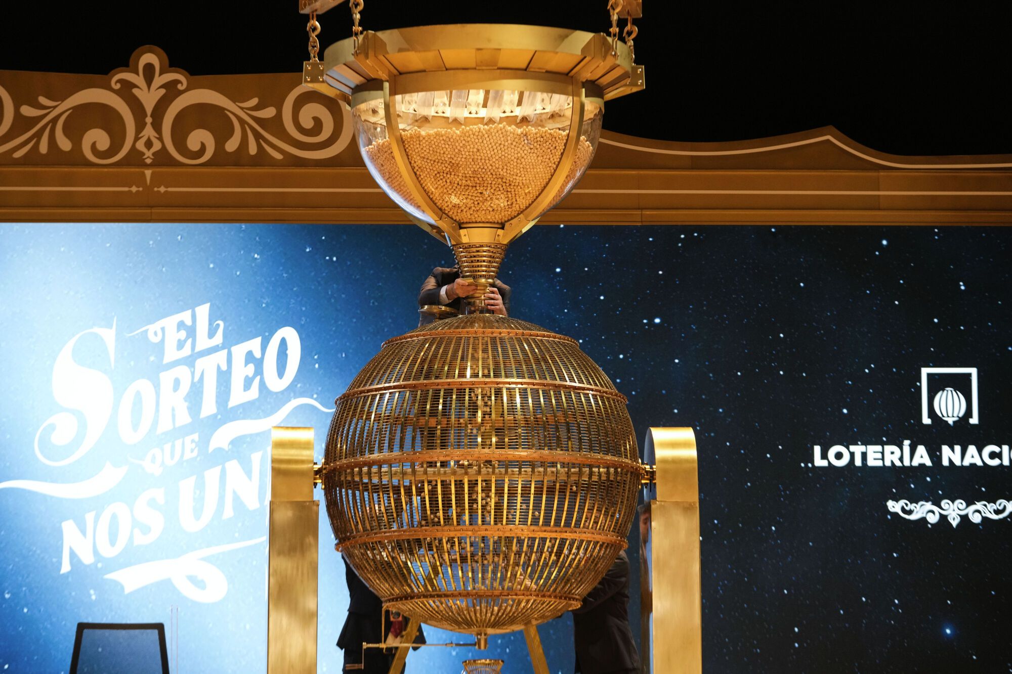 Staff prepare numbered lottery balls before the start of Spain's bumper Christmas lottery draw, known as El Gordo, or The Fat One, at Madrid's Teatro Real, Spain, Sunday, Dec. 22, 2024. (AP Photo/Bernat Armangue)