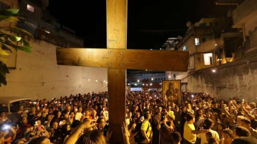 La cruz peregrina, por las calles de la Rocinha, la mayor favela de Río de Janeiro, abarrotadas de gente. / efe