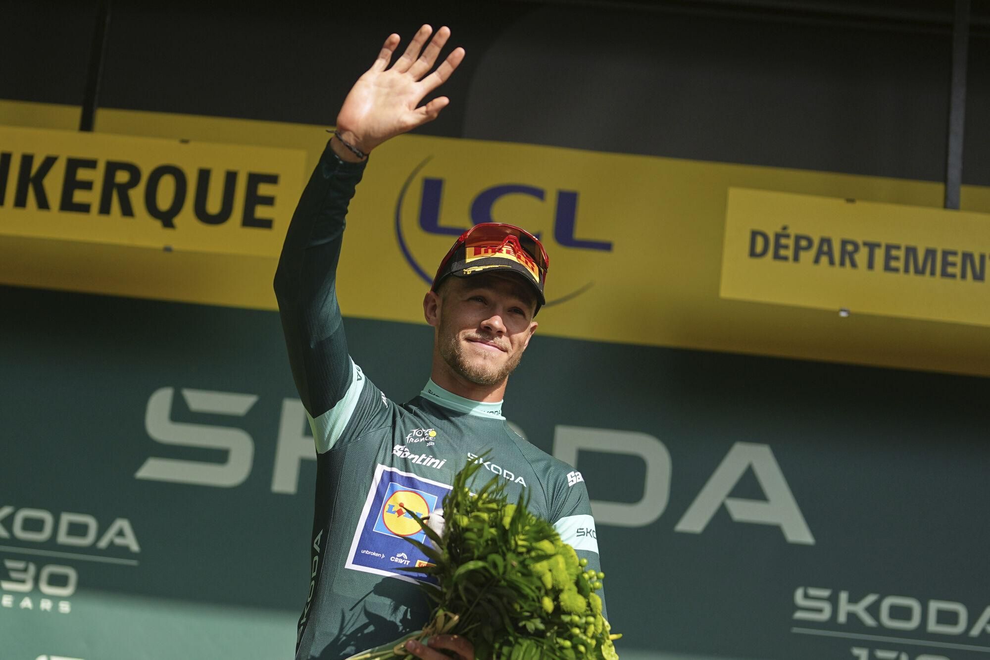 Italy's Jonathan Milan wearing the best sprinter's green jersey celebrates on the podium after the third stage of the Tour de France cycling race over 178.3 kilometers (110.8 miles) with start in Valenciennes and finish in Dunkerque, France, Monday, July 7, 2025. (AP Photo/Thibault Camus)