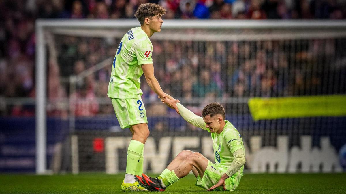 Cubarsí ayuda a Casadó a levantarse tras sufrir la lesión en la rodilla derecha ante el Atlético.