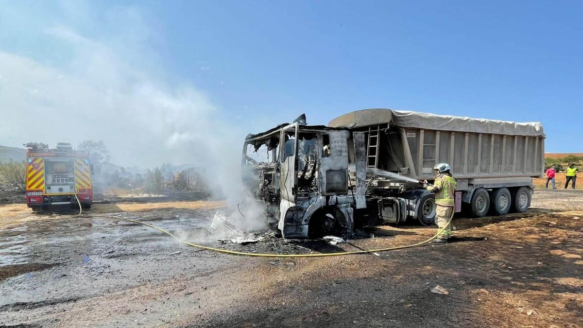 Bomberos sofocan las llamas del camión.