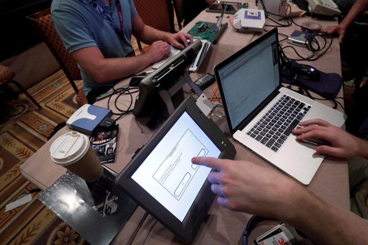 FILE PHOTO: Hackers try to access and alter data from an electronic poll books in a Voting Machine Hacking Village during the Def Con hacker convention in Las Vegas, Nevada, U.S., July 29, 2017. REUTERS/Steve Marcus/File Photo FILE PHOTO: Hackers try to access and alter data from an electronic poll books in a Voting Machine Hacking Village during the Def Con hacker convention in Las Vegas, Nevada, U.S., July 29, 2017. REUTERS/Steve Marcus/File Photo