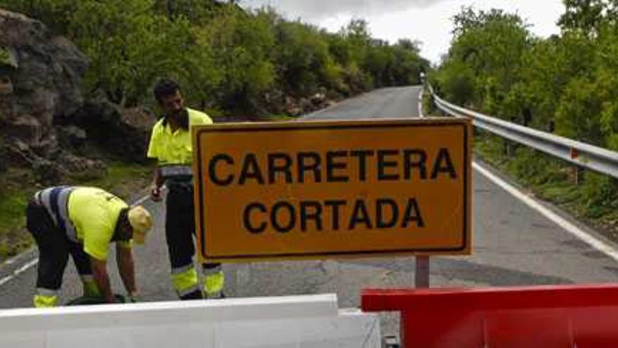 Dos operarios de carreteras del Cabildo cortan una vía en el municipio de San Bartolomé de Tirajana. | andrés cruz