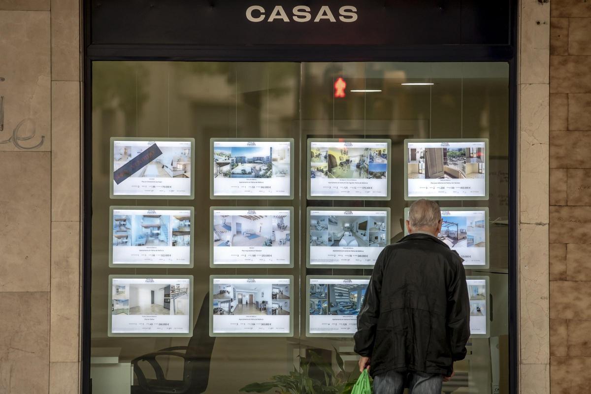 Una persona mira ofertas de alquiler en una inmobiliaria