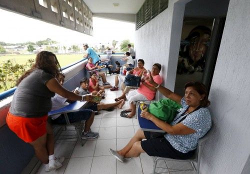 Residents, who were evacuated from their homes wait at the University of Puerto Vallarta used as a shelter as Hurricane Patricia approaches the Pacific beach resort of Puerto Vallarta