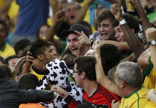 Brazil's Neymar celebrates with fans after scoring a goal during their Confederations Cup final soccer match against Spain at the Estadio Maracana in Rio de Janeiro