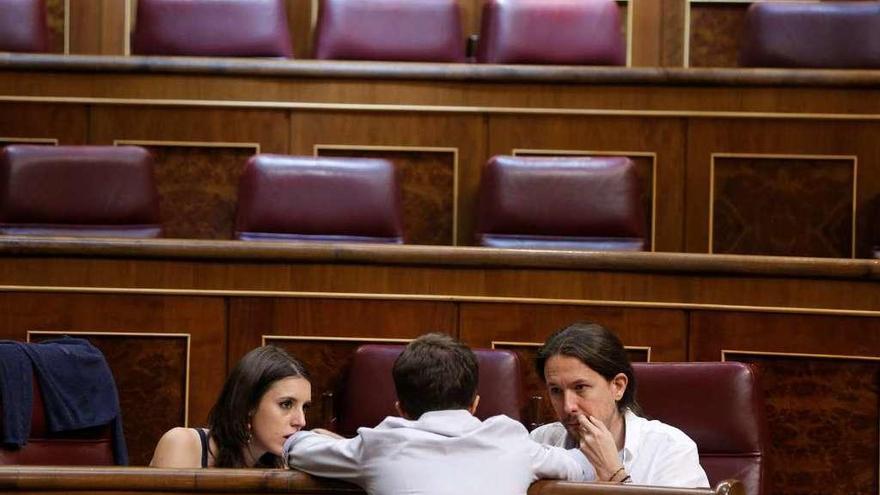 Errejón (de espaldas), hablando con Montero e Iglesias en el Congreso. // Reuters