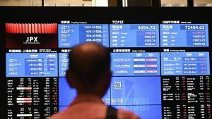 Share prices displayed on a screen at the Tokyo Stock Exchange (TSE) building, operated by Japan Exchange Group Inc. (JPX), in Tokyo, Japan, on Monday, June 22, 2026. Japanese stocks advanced with buying of artificial-intelligence and semiconductor shares pushing benchmark indexes higher. Photographer: Soichiro Koriyama/Bloomberg