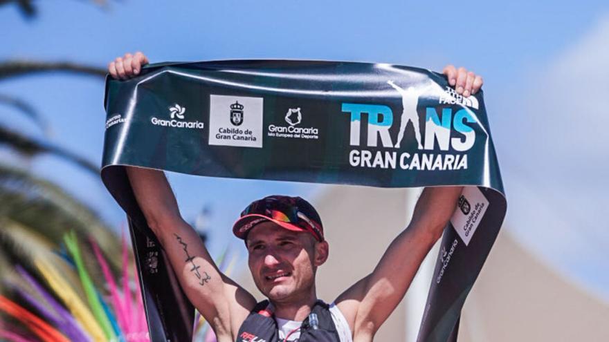 Raúl Octaviu Butaci alza la cinta de la línea de meta de la Transgrancanaria que le acredita como campeón este año. | | JORDI SARAGOSSA