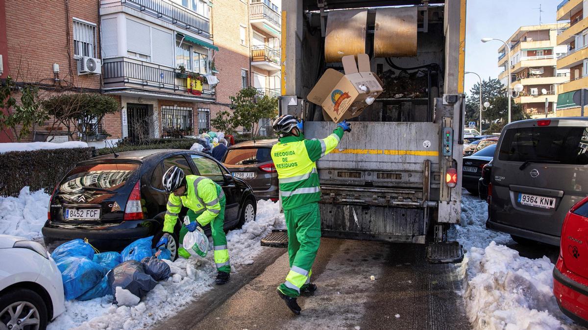 Operarios del servicio de limpieza de Madrid recogen las toneladas de basura acumuladas tras la nevada, este miércoles.